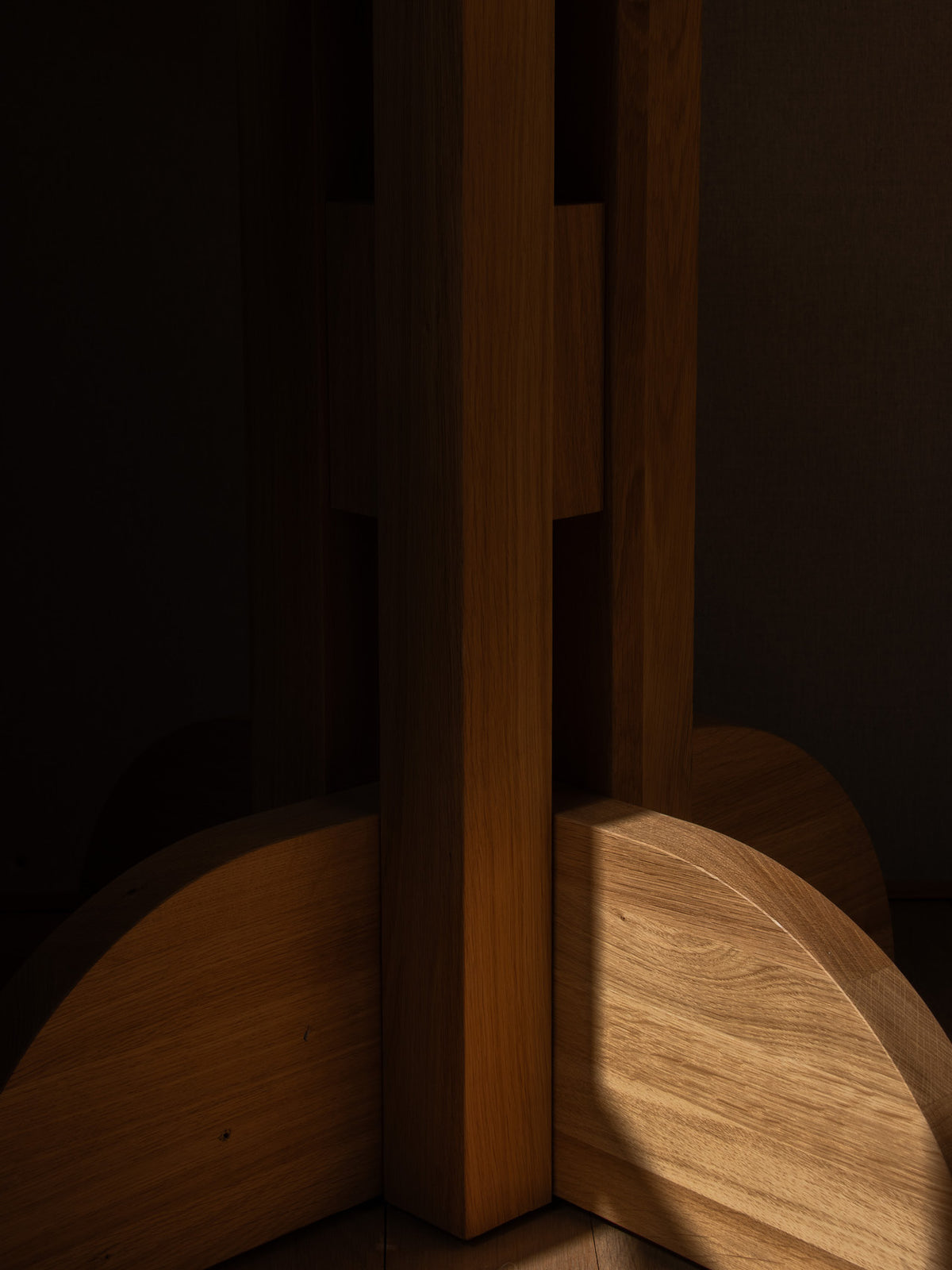 Close-up of warm oak wooden furniture base with vertical rectangular posts and