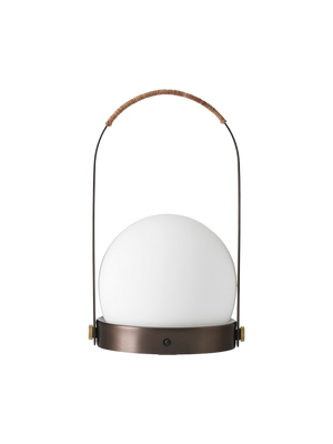 Front view of the Carrie Table Lamp in bronzed brass, featuring a white opal glass orb and a handle wrapped in brown leather.