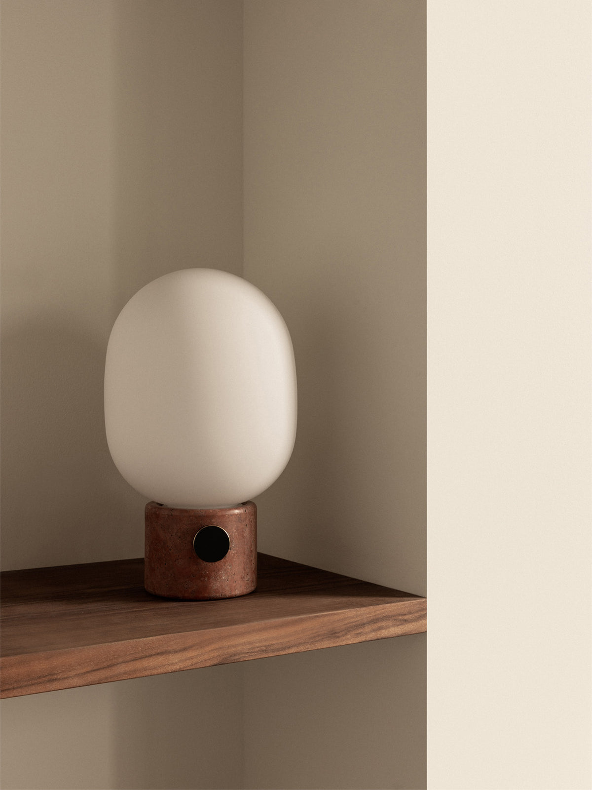 Minimal table lamp with matte white oval glass shade and cylindrical reddish-bro