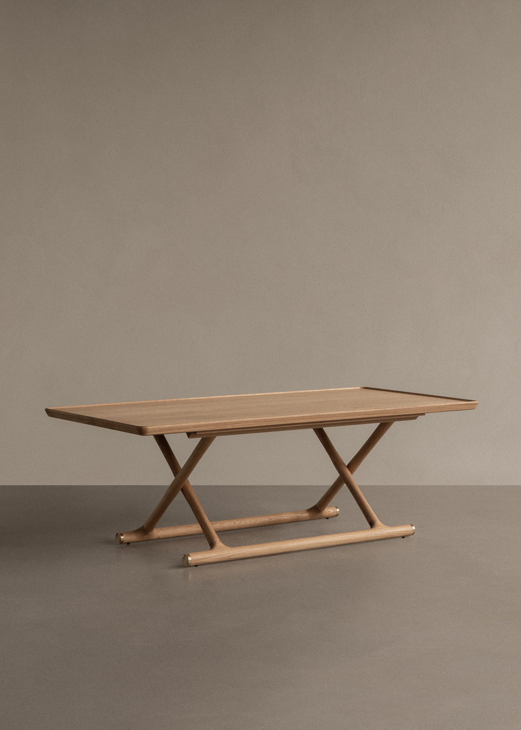 Oak coffee table with rectangular top and X-shaped legs on rounded stretcher,