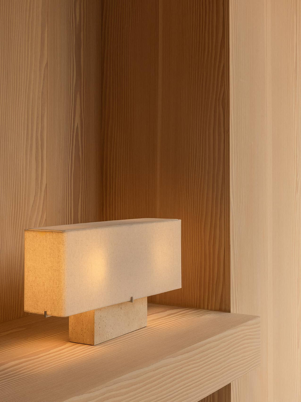 Rectangular beige fabric table lamp with stone base on light natural wood
