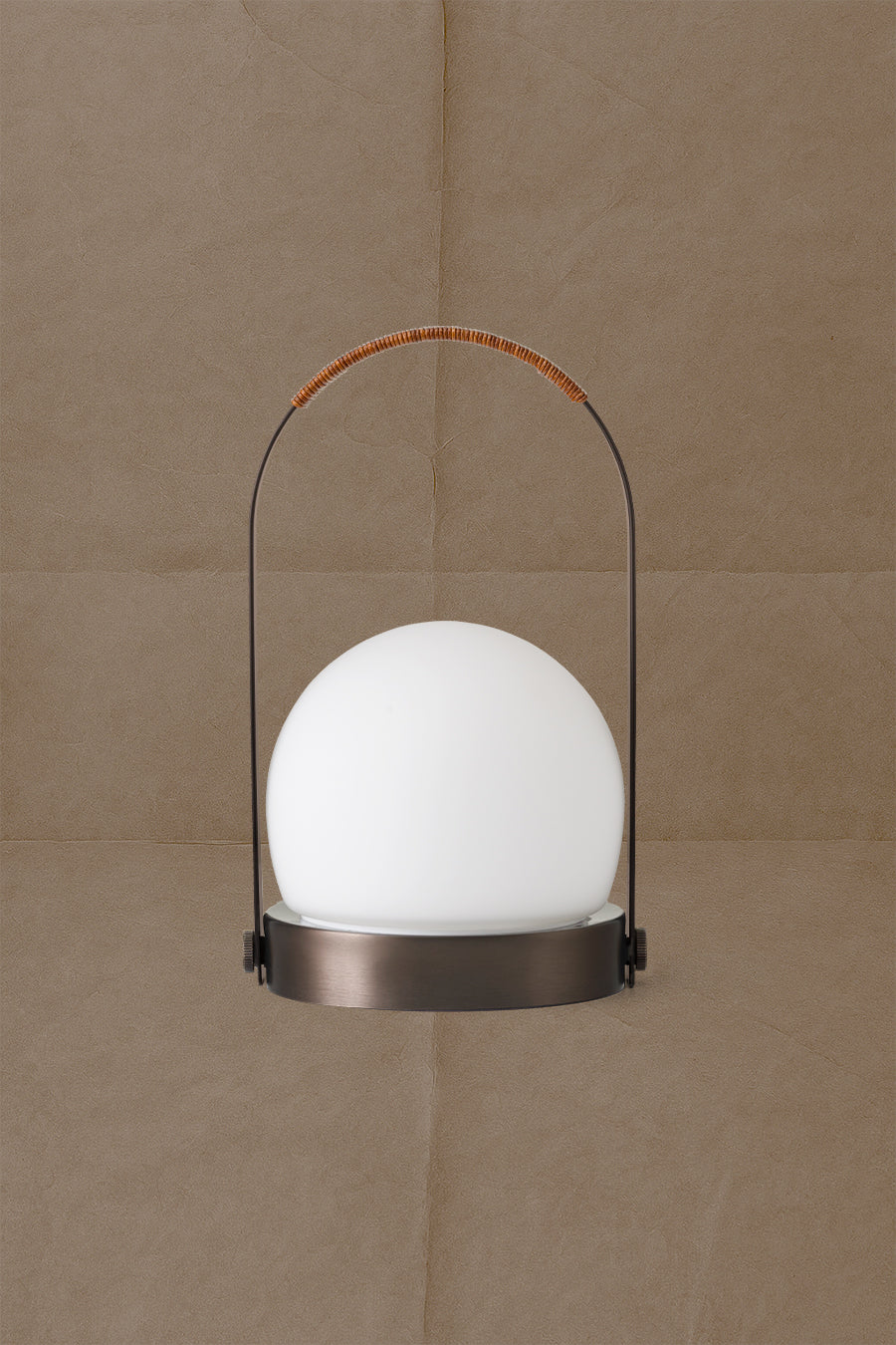 Portable table lamp with white frosted glass globe, bronze metal base and