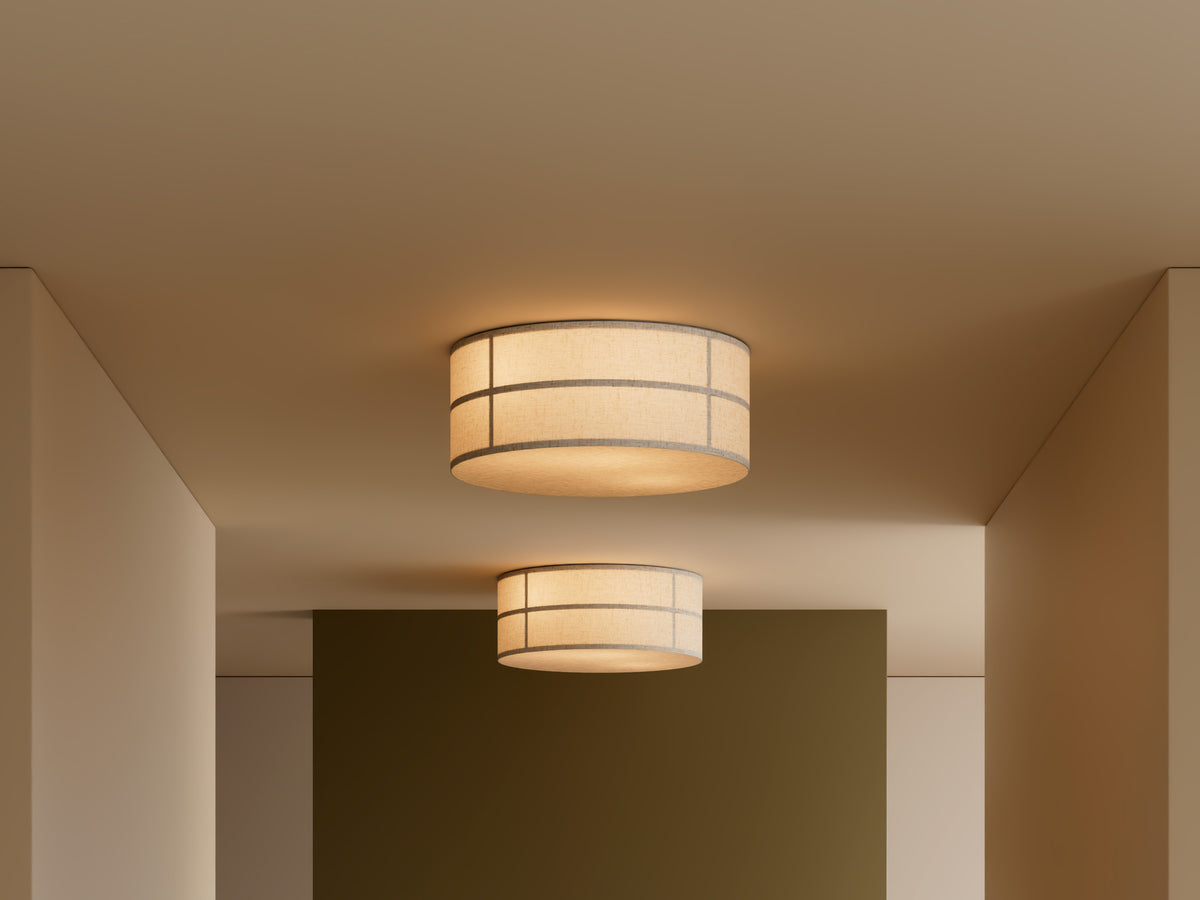 Beige fabric drum ceiling lamp with thin gray grid lines, warm light