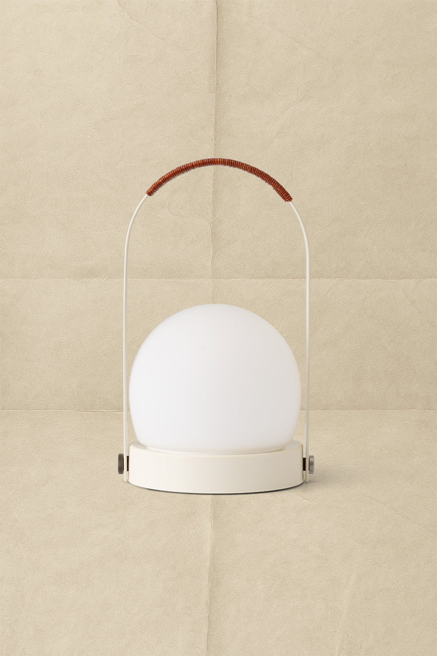 Cream portable table lamp with matte white glass globe, beige metal base