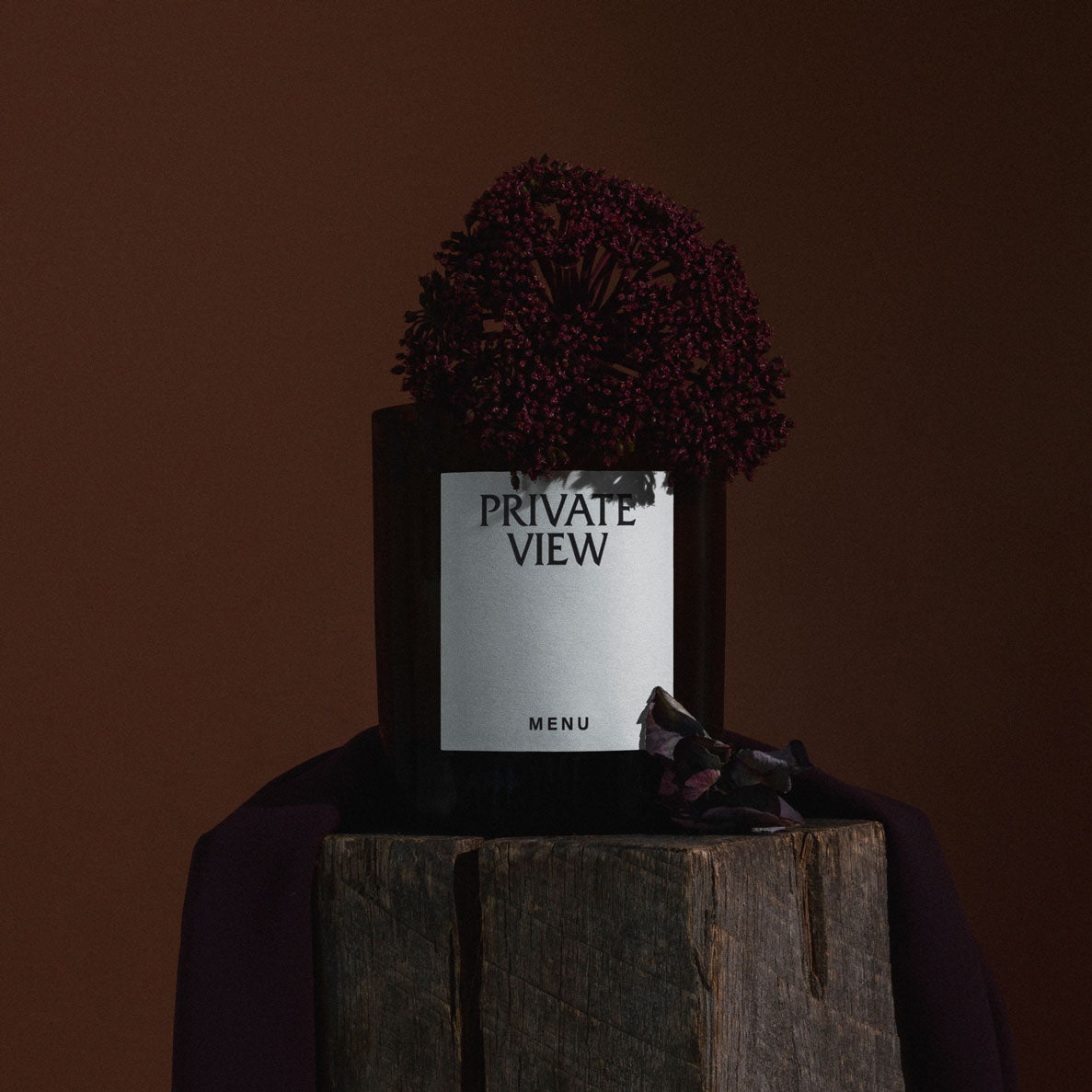 Black square glass candle jar labeled "PRIVATE VIEW" with dark purple dried