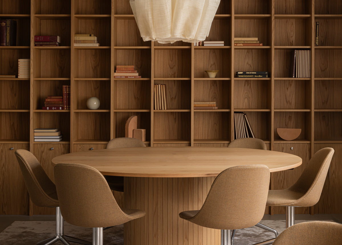 Round oak dining table with fluted pedestal, four brown upholstered swivel chair