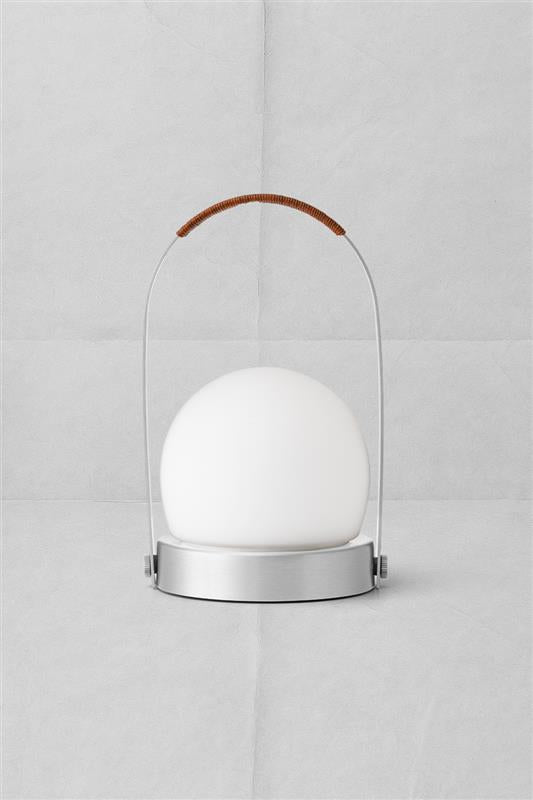 Portable table lamp with white frosted globe, brushed metal base and arched
