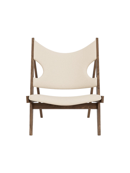 A front view of the Knitting Lounge Chair, with a dark wood frame and off-white textile seat and back with elbow cut-outs.