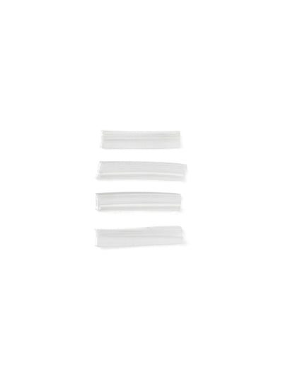 Four small, slightly curved, translucent plastic components with a ribbed texture, stacked vertically on a white background.