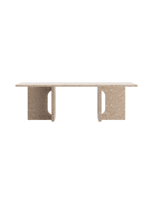 A straight-on shot of the Androgyne Lounge Table in Kunis Breccia stone, with its rectangular top and two wide, cutout legs.