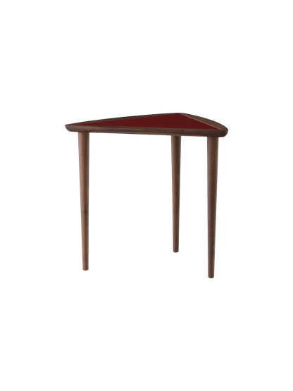 The Umanoff Nesting Side Table with a walnut frame, three legs, and a triangular burgundy top on a black background.
