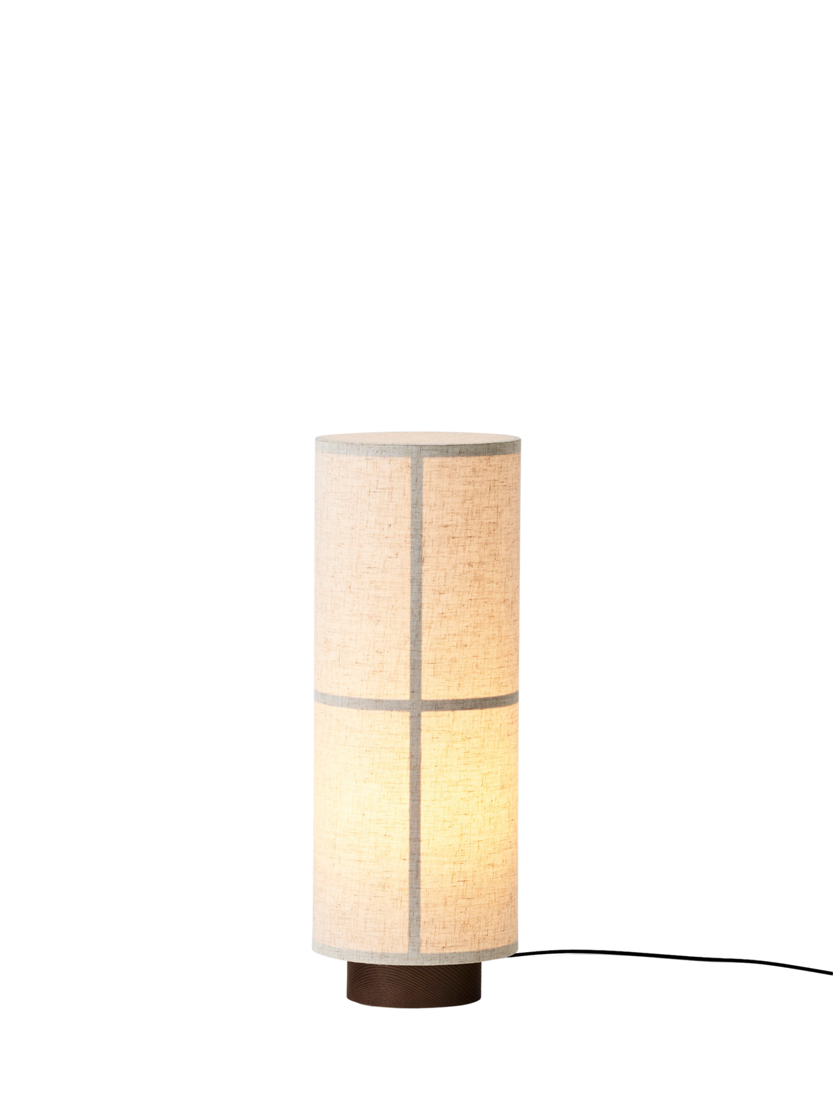 Hashira Table Lamp in raw linen, showcasing a cylindrical translucent shade with a wooden ash base and glowing warm light.