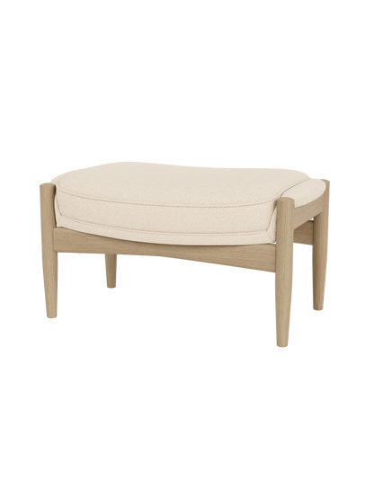 The Seal Ottoman in Natural Oak with Logan Jasmine fabric upholstery, featuring organic mid-century modern curves.