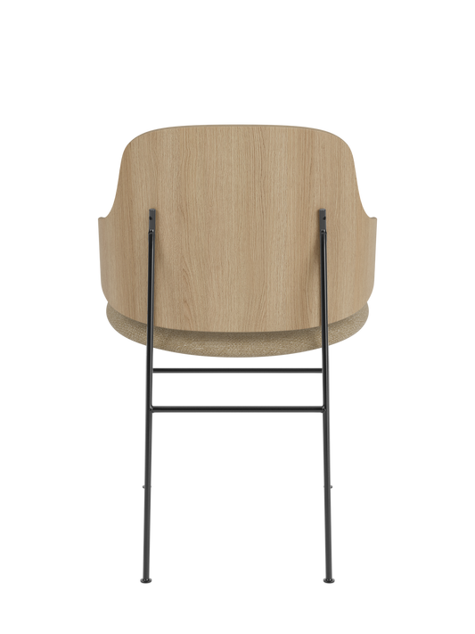 The Penguin Dining Chair in natural oak with a textured bouclé seat and slim black steel frame, seen from the back.