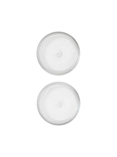 Top-down view of two translucent plastic round spare parts for the Tired Man Lounge Chair wheels on a black background.