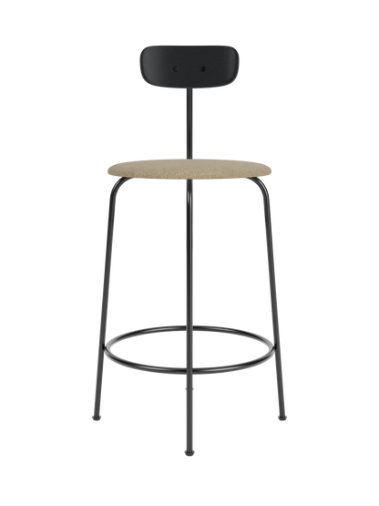 Afteroom Counter Chair with a black painted oak back, beige bouclé upholstered seat and minimalist black steel frame.