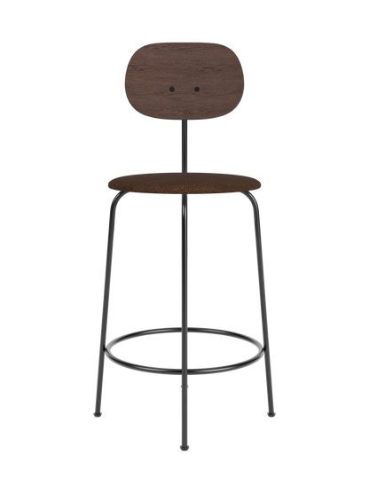 Afteroom Counter Chair Plus with a dark stained oak backrest and brown bouclé upholstered seat on a black metal frame.