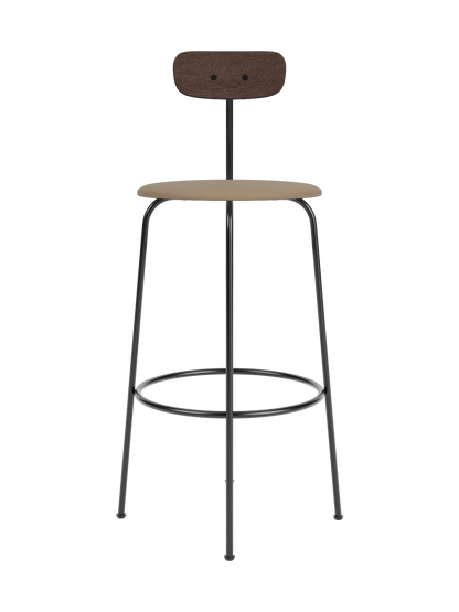 Afteroom Bar Chair with a dark stained oak backrest and tan upholstered seat on a four-legged black steel frame.