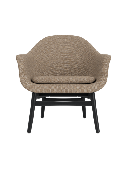 Harbour Lounge Chair featuring Logan Flint textured upholstery and a black painted oak base with a curved shell.