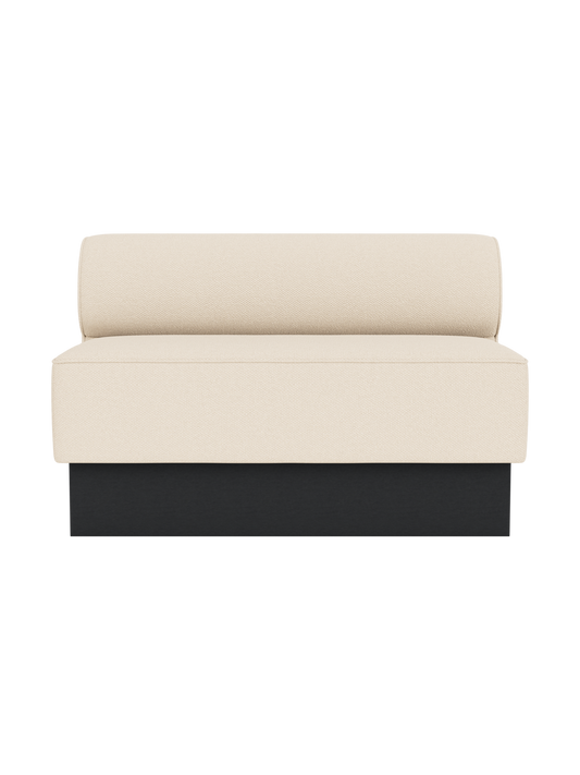 Eave Dining Sofa, Plateau in Logan Jasmine upholstery with a black painted oak base, viewed from the front.