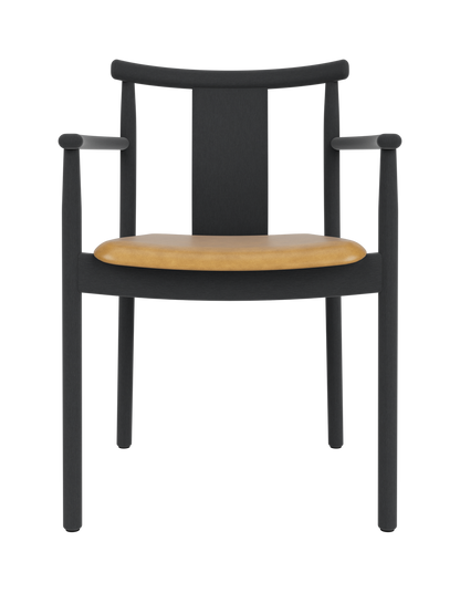 Merkur Dining Chair with armrests in black stained oak, featuring a tan leather upholstered seat.