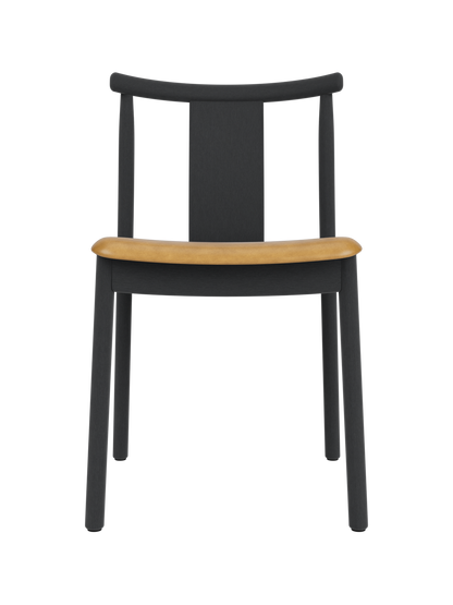 Merkur Dining Chair in black stained oak with a tan upholstered seat, showcasing its modern solid wood design.