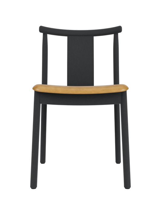Merkur Dining Chair in black stained oak with a tan upholstered seat, showcasing its modern solid wood design.