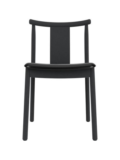 Merkur Dining Chair in black-stained oak with a black leather seat, featuring a curved backrest and minimalist wood frame.