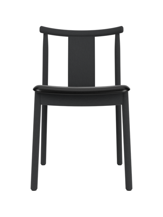 Merkur Dining Chair in black-stained oak with a black leather seat, featuring a curved backrest and minimalist wood frame.