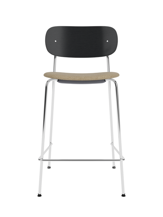 Co Counter Chair with a black painted oak backrest, bouclé upholstered seat, and chrome frame against a black background.