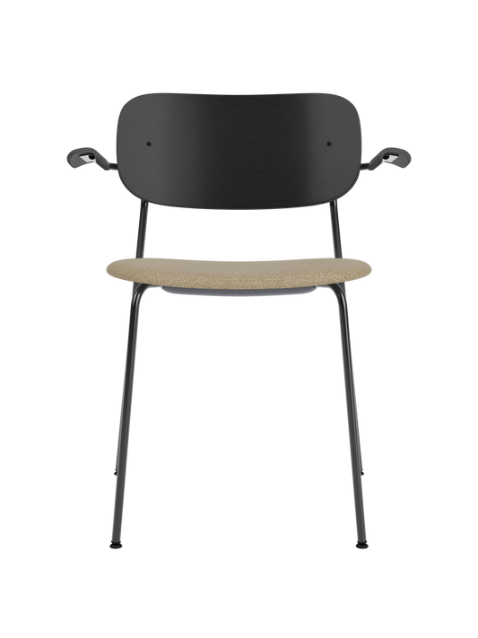 Co Dining Chair with armrests, a black oak backrest and a sand bouclé upholstered seat on a black metal frame.