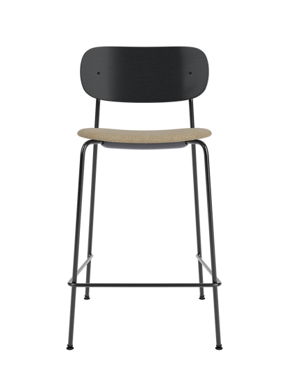 Co Counter Chair in black painted oak with a textured bouclé seat cushion on a slender black steel frame.