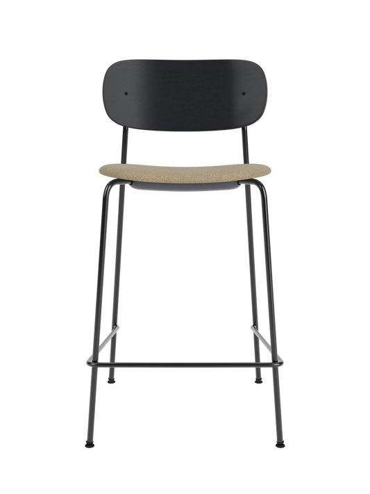 Co Counter Chair in black painted oak with a textured bouclé seat cushion on a slender black steel frame.