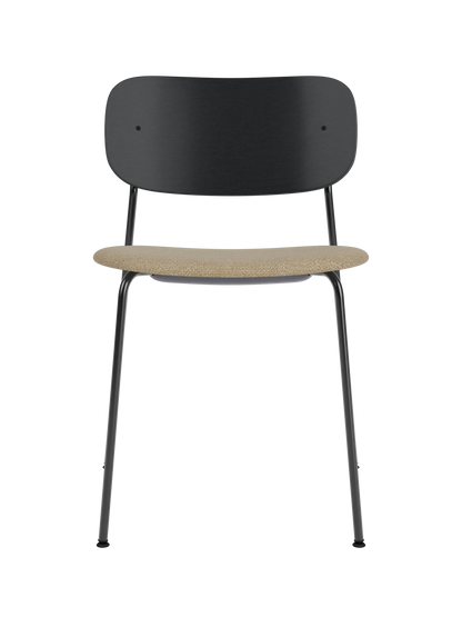 Co Dining Chair with a black painted oak backrest, slim steel frame and a textured beige Audo Bouclé upholstered seat.