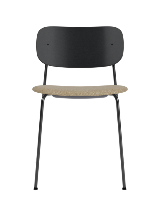 Co Dining Chair with a black painted oak backrest, slim steel frame and a textured beige Audo Bouclé upholstered seat.