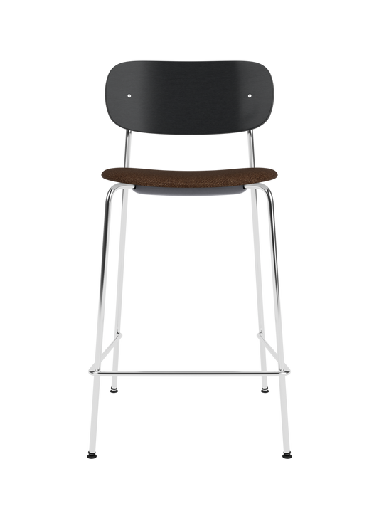 Co Counter Chair with a black painted oak back, bouclé upholstery seat, and chrome frame against a black background.