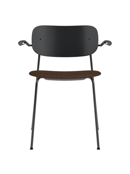 Co Dining Chair with armrests, black frame, black painted oak backrest, and a textured brown bouclé upholstered seat.