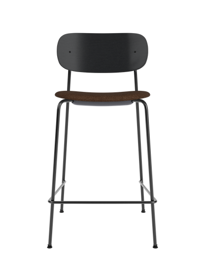 Co Counter Chair with black oak back and brown bouclé upholstered seat on a slender black powder-coated steel frame.