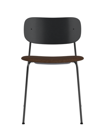 Co Dining Chair featuring a black steel frame, wide black oak backrest, and a brown bouclé upholstered seat.