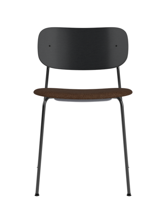 Co Dining Chair featuring a black steel frame, wide black oak backrest, and a brown bouclé upholstered seat.