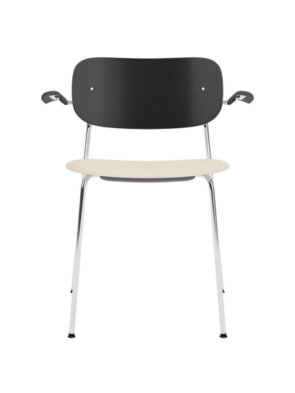 Co Dining Chair with armrests, featuring a black oak back and Logan Jasmine upholstered seat on a slim chrome frame.