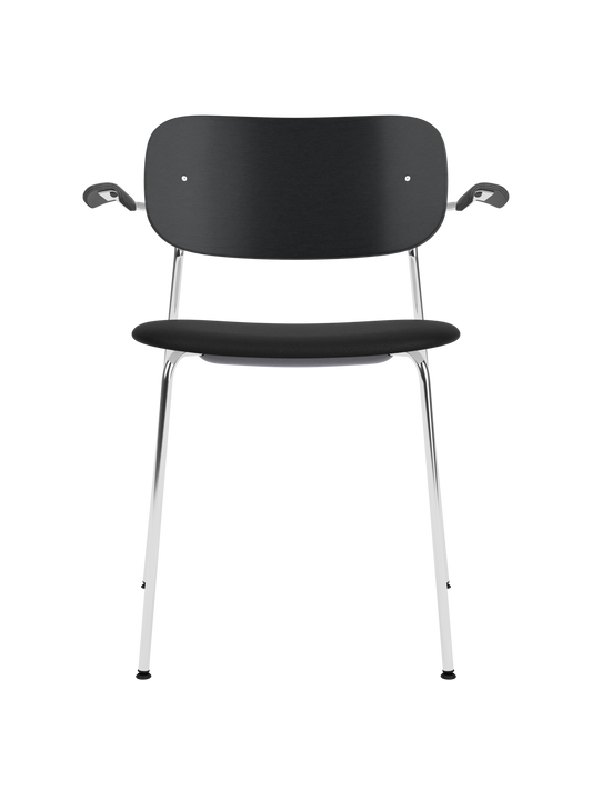 Co Dining Chair with armrests featuring a chrome frame, black painted oak backrest and black Sierra 1001 upholstered seat.