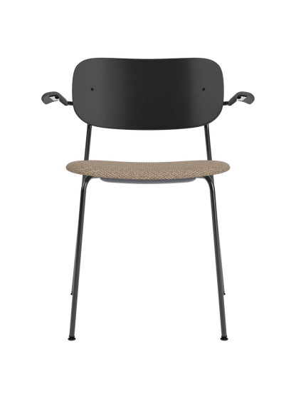 Co Dining Chair with armrests, black painted oak backrest and a textured Logan Flint upholstered seat on a black frame.