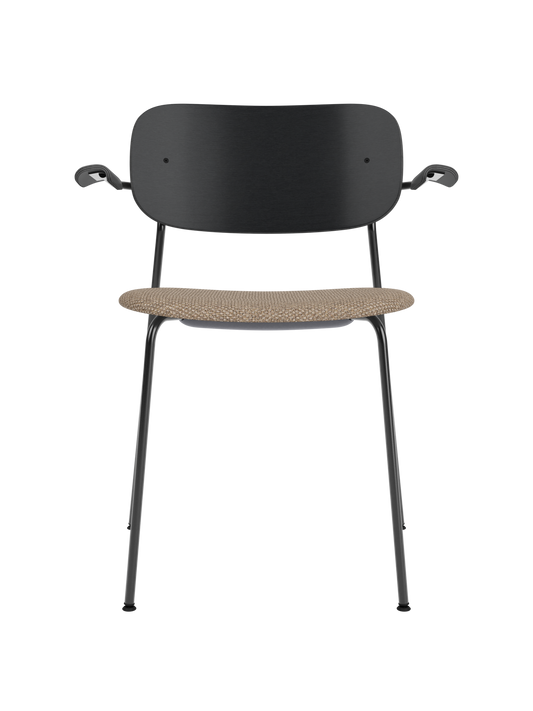 Co Dining Chair with armrests, black painted oak backrest and a textured Logan Flint upholstered seat on a black frame.