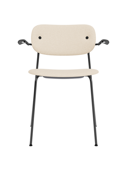 Co Dining Chair with armrests, fully upholstered in Logan Jasmine fabric with a black oak frame and steel legs.