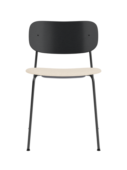 Co Dining Chair with black painted oak backrest, cream Logan Jasmine upholstered seat, and a black steel frame.