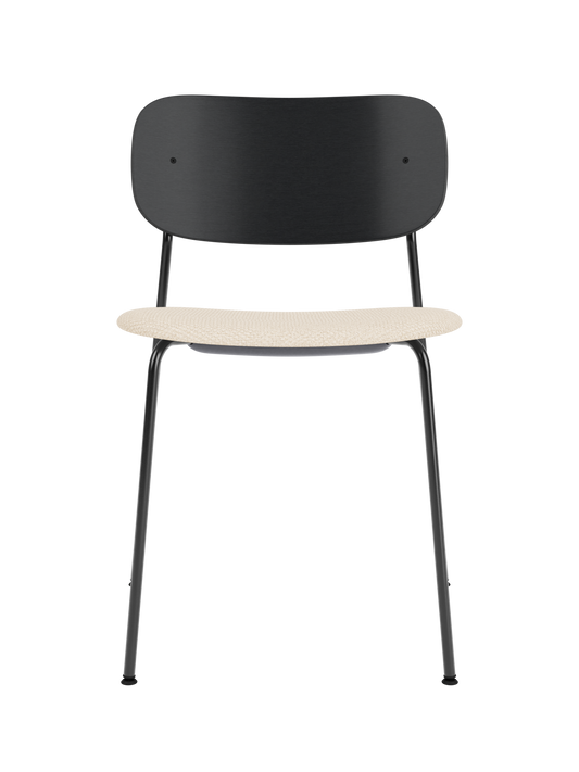 Co Dining Chair with black painted oak backrest, cream Logan Jasmine upholstered seat, and a black steel frame.