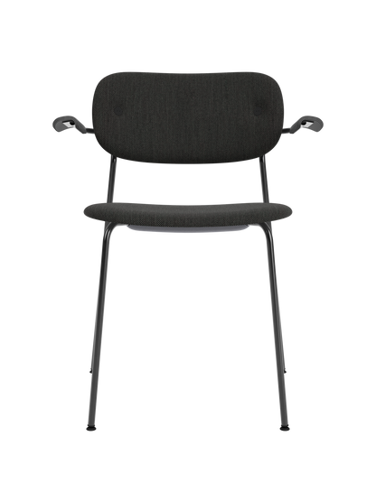 Fully upholstered Co Dining Chair with black oak armrests, black Re-wool fabric, and a powder-coated steel frame.