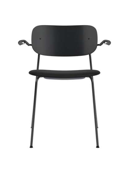 Co Dining Chair with armrests, featuring a black painted oak backrest and Sierra leather seat on a sleek steel frame.