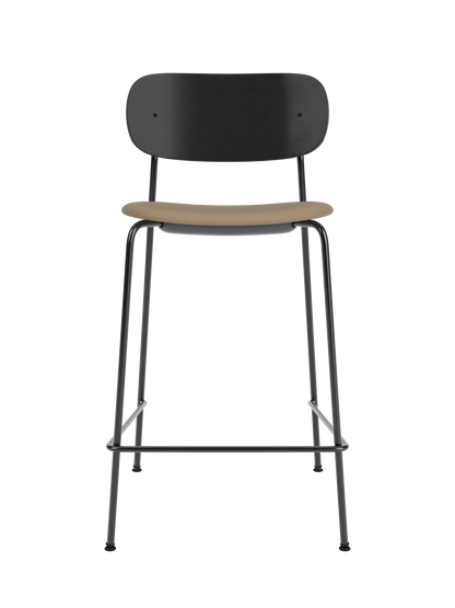 Black oak Co Counter Chair featuring a tan Sierra upholstered seat and slender black steel frame with a footrest.